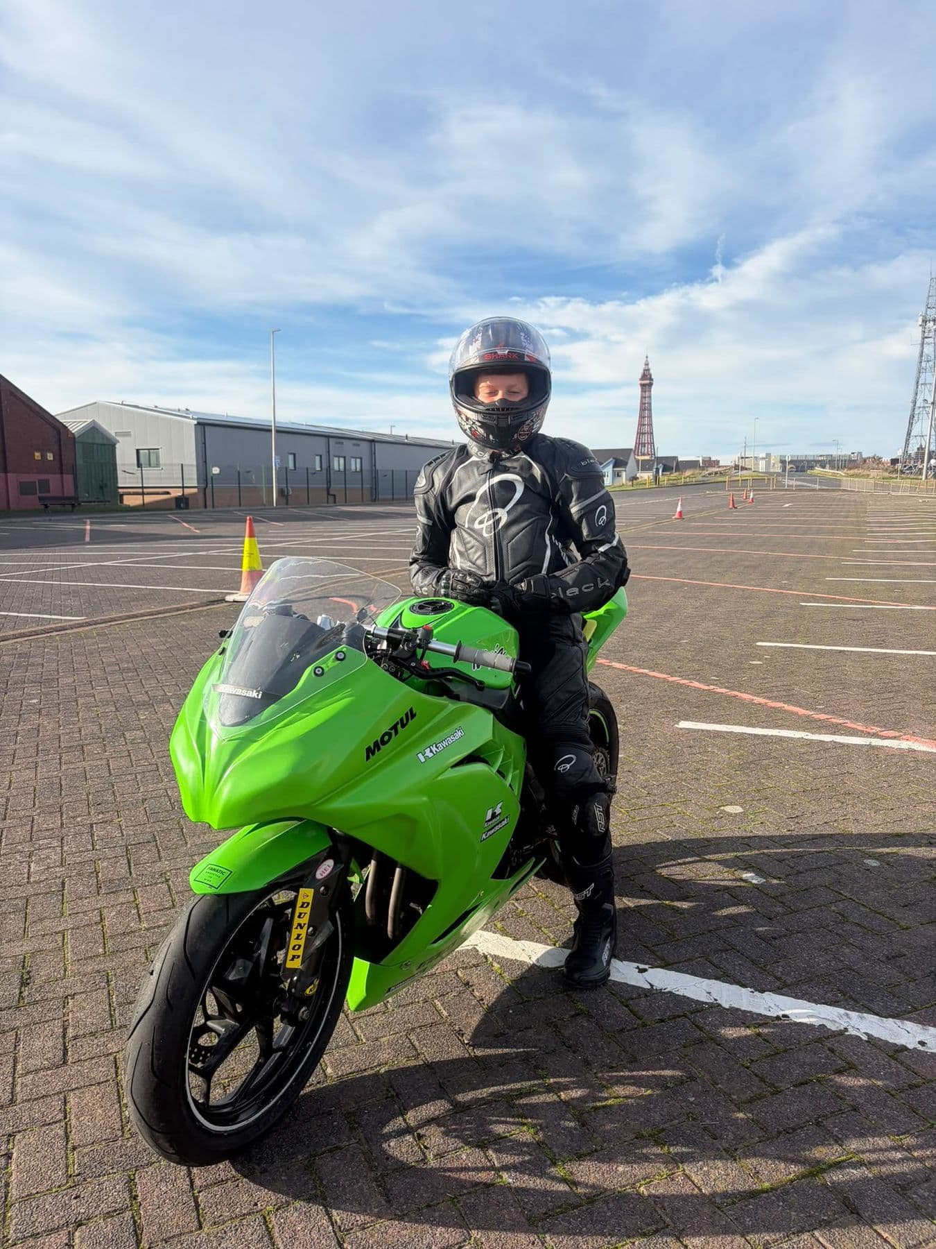 Ted on a training bike with Blackpool Tower behind