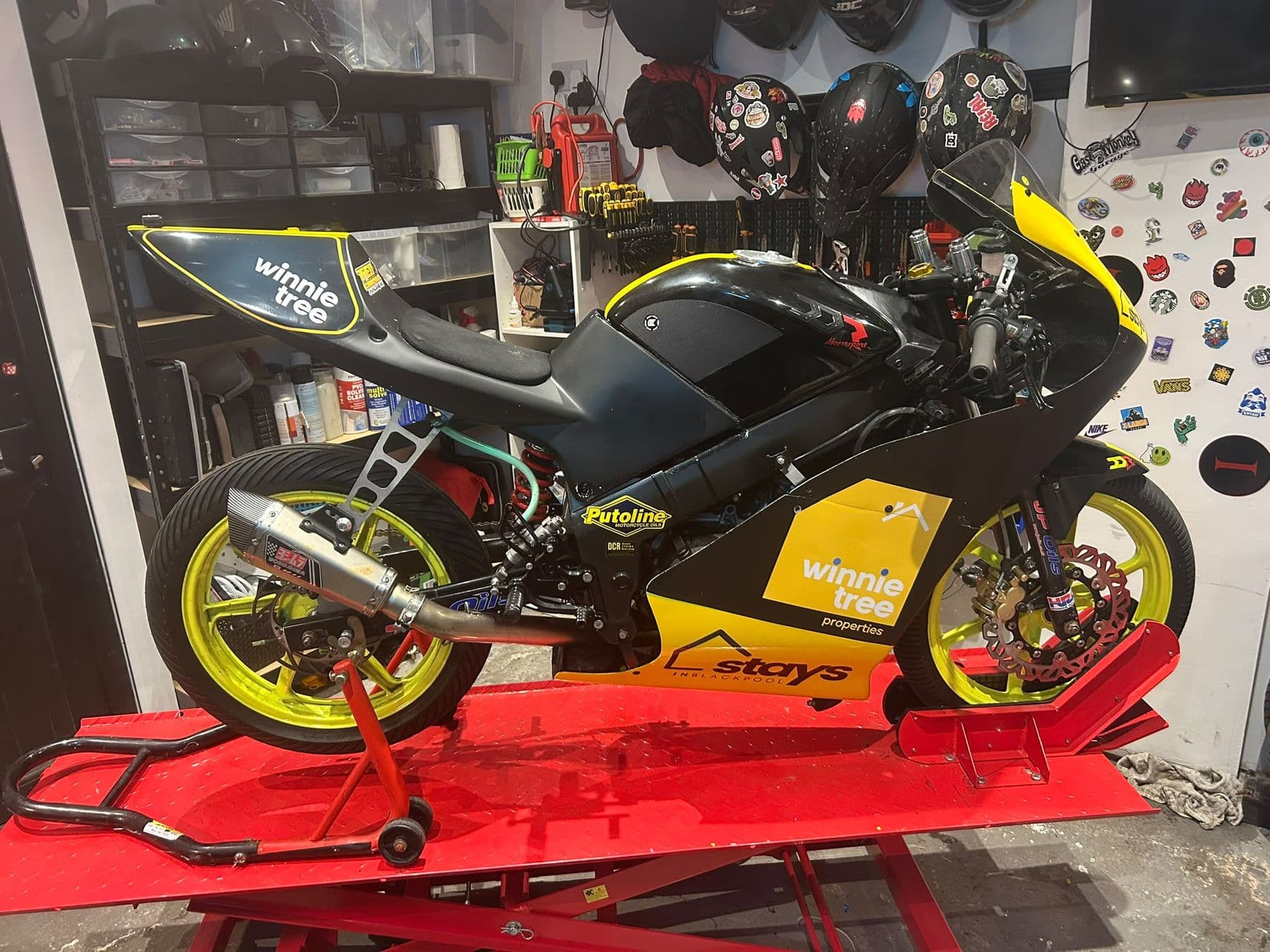 Ted's black-and-yellow race bike up on the lift in the home garage