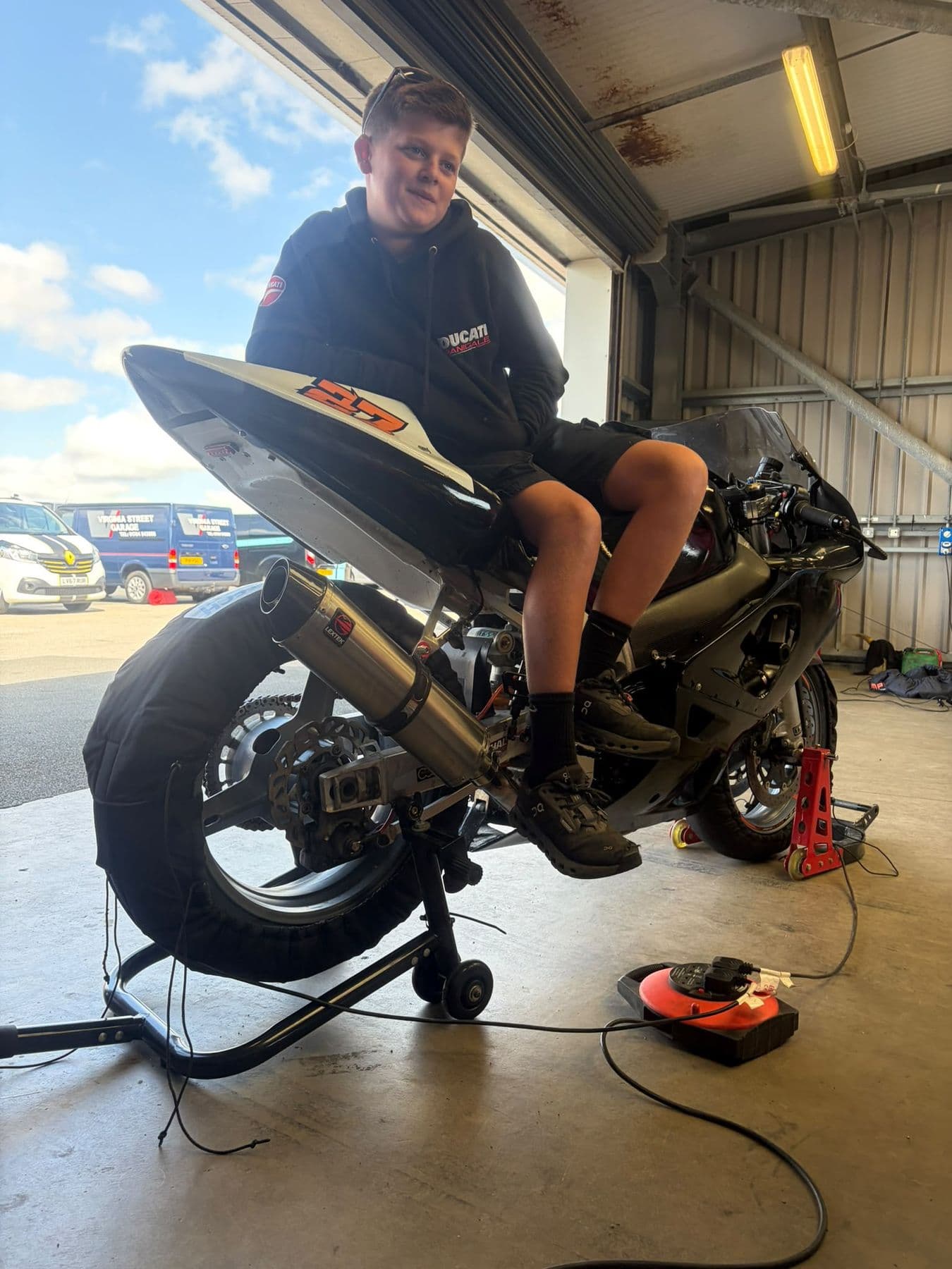Ted sitting on the bike in the garage