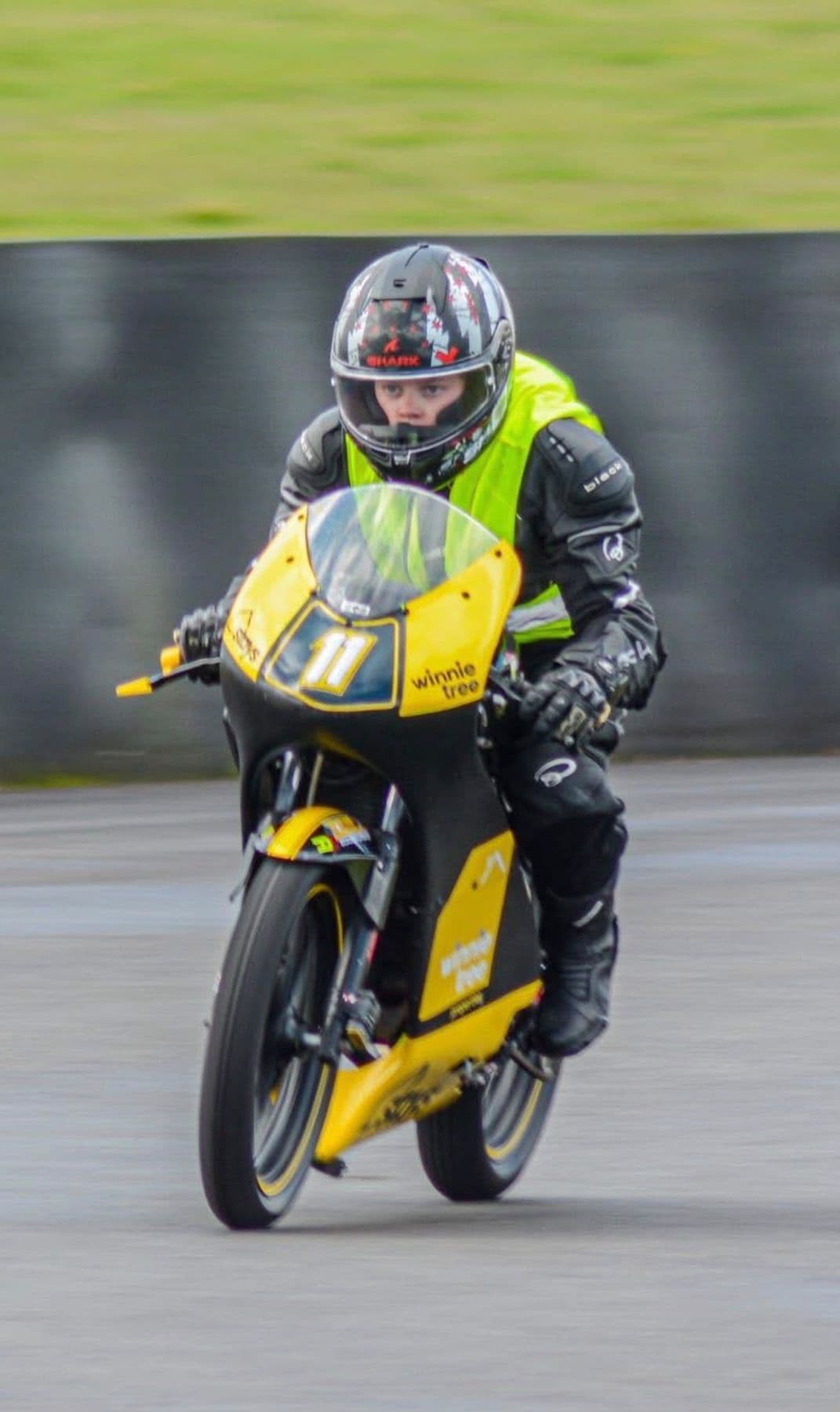 Ted riding towards the camera in a hi-vis vest