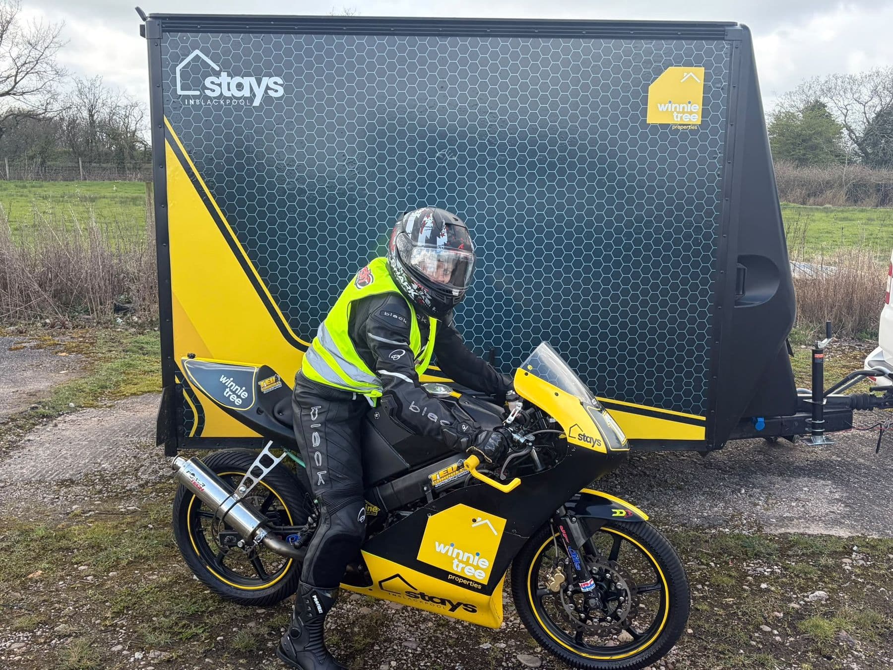 Ted on the bike beside the team trailer