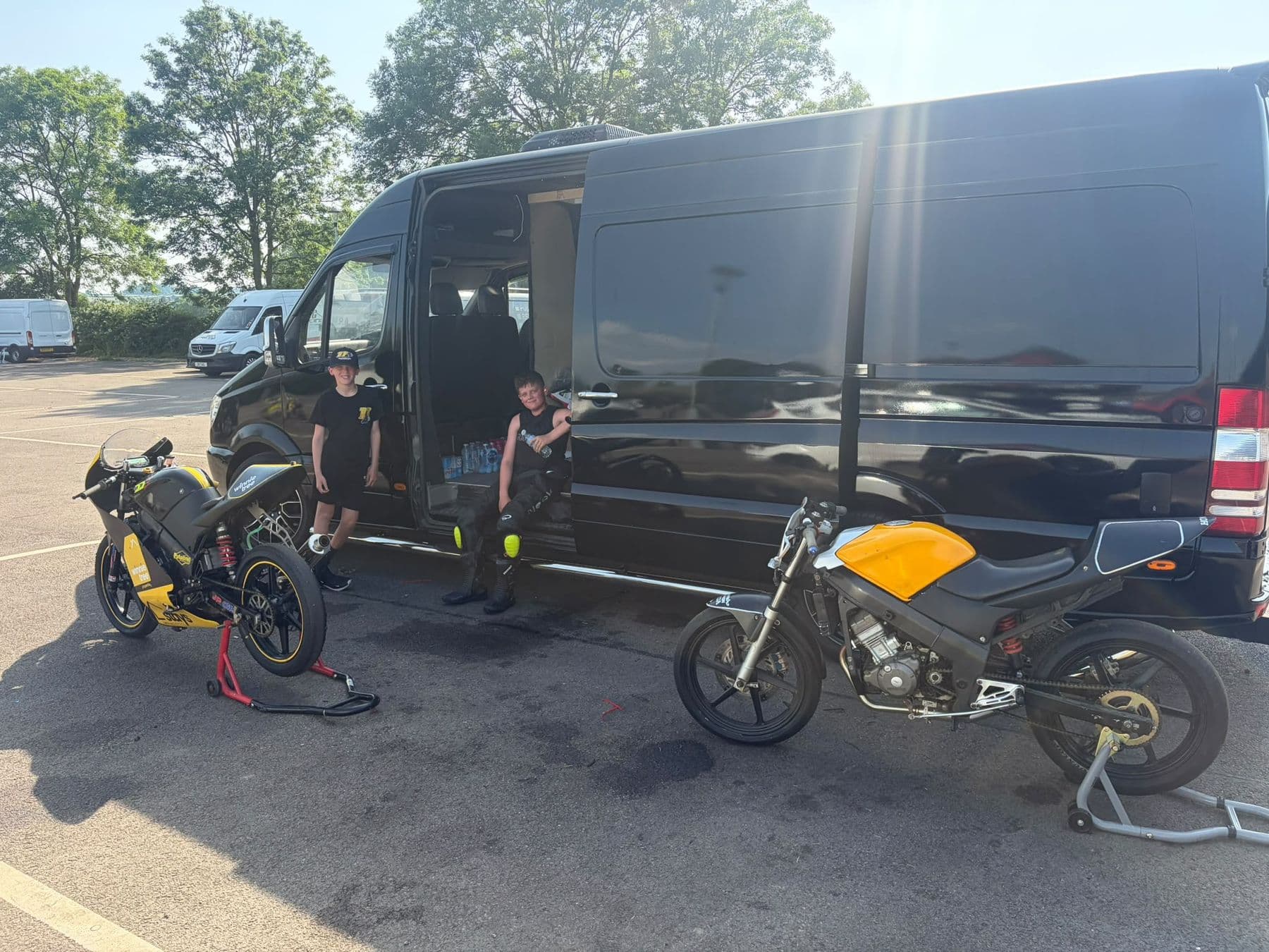 The team van and bikes in the paddock